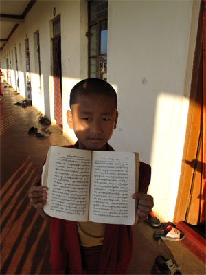 Young monk with text